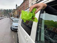 Image of litter being thrown out of a van window Image of litter being thrown out of a van window