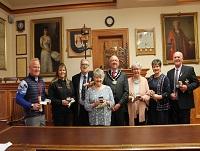 Image of a group of people receiving awards from the former Chairman of Powys County Council Image of a group of people receiving awards from the former Chairman of Powys County Council