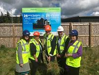 Image of people at turf-cutting ceremony in Newtown