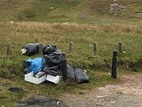 Image of fly-tipping on a road layby Image of fly-tipping on a road layby