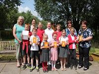 Image of pupils with vouchers after winning recycling competition